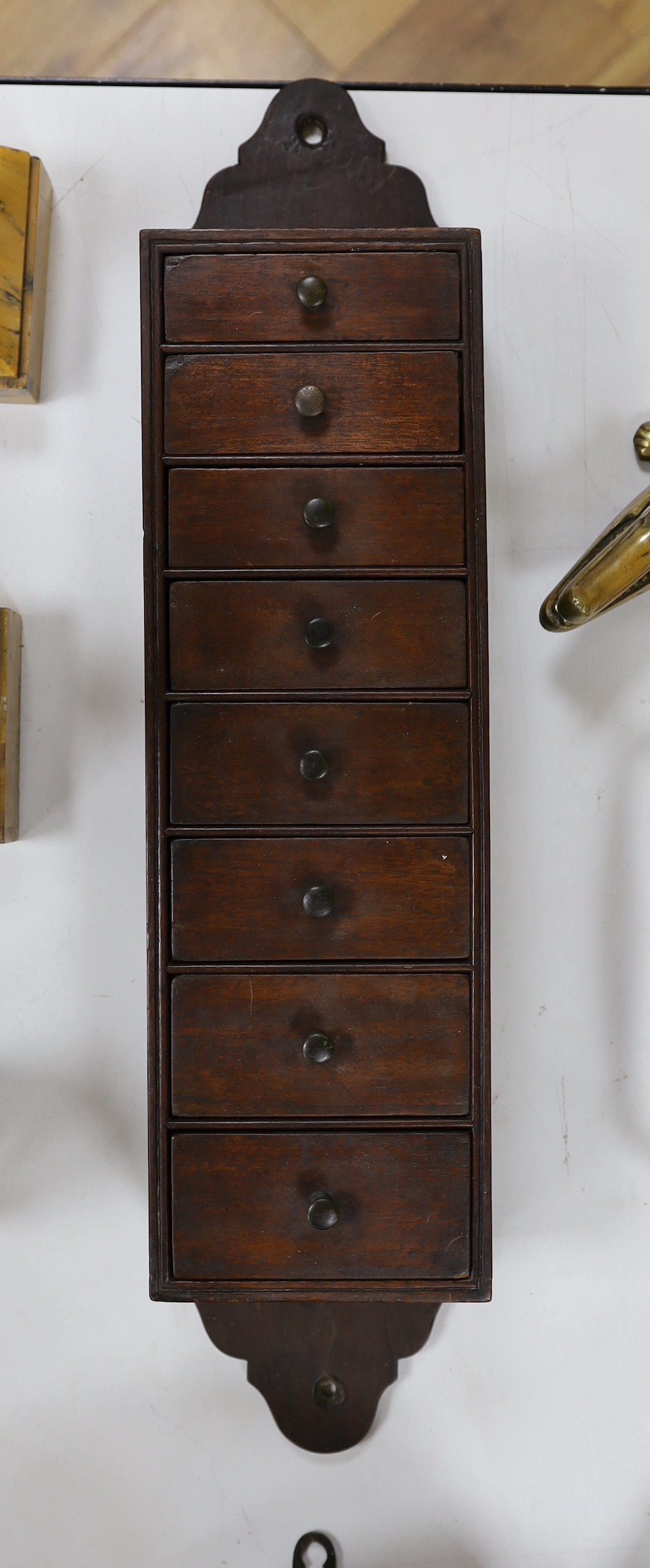 A Regency wall mounting eight drawer spice cupboard, 66cm long